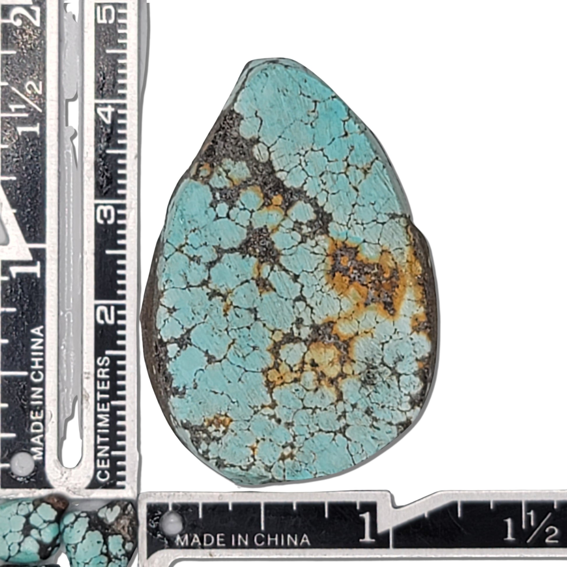 A 22-gram teardrop-shaped turquoise rough stone with vibrant blue hues and intricate black and golden matrix. Ideal for custom jewelry or lapidary projects, available at www.naturalturquoise.com.