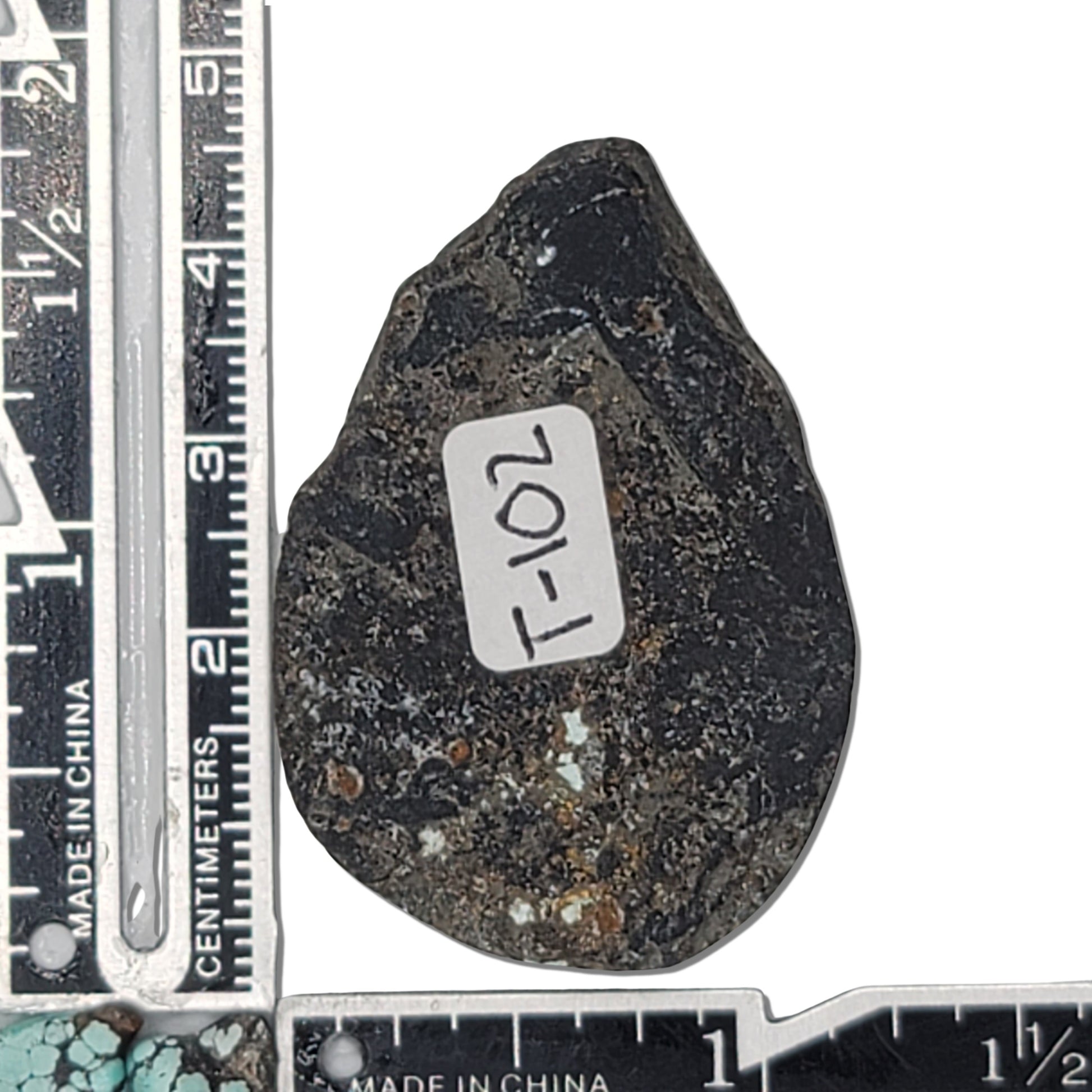 A 22-gram teardrop-shaped turquoise rough stone with vibrant blue hues and intricate black and golden matrix. Ideal for custom jewelry or lapidary projects, available at www.naturalturquoise.com.