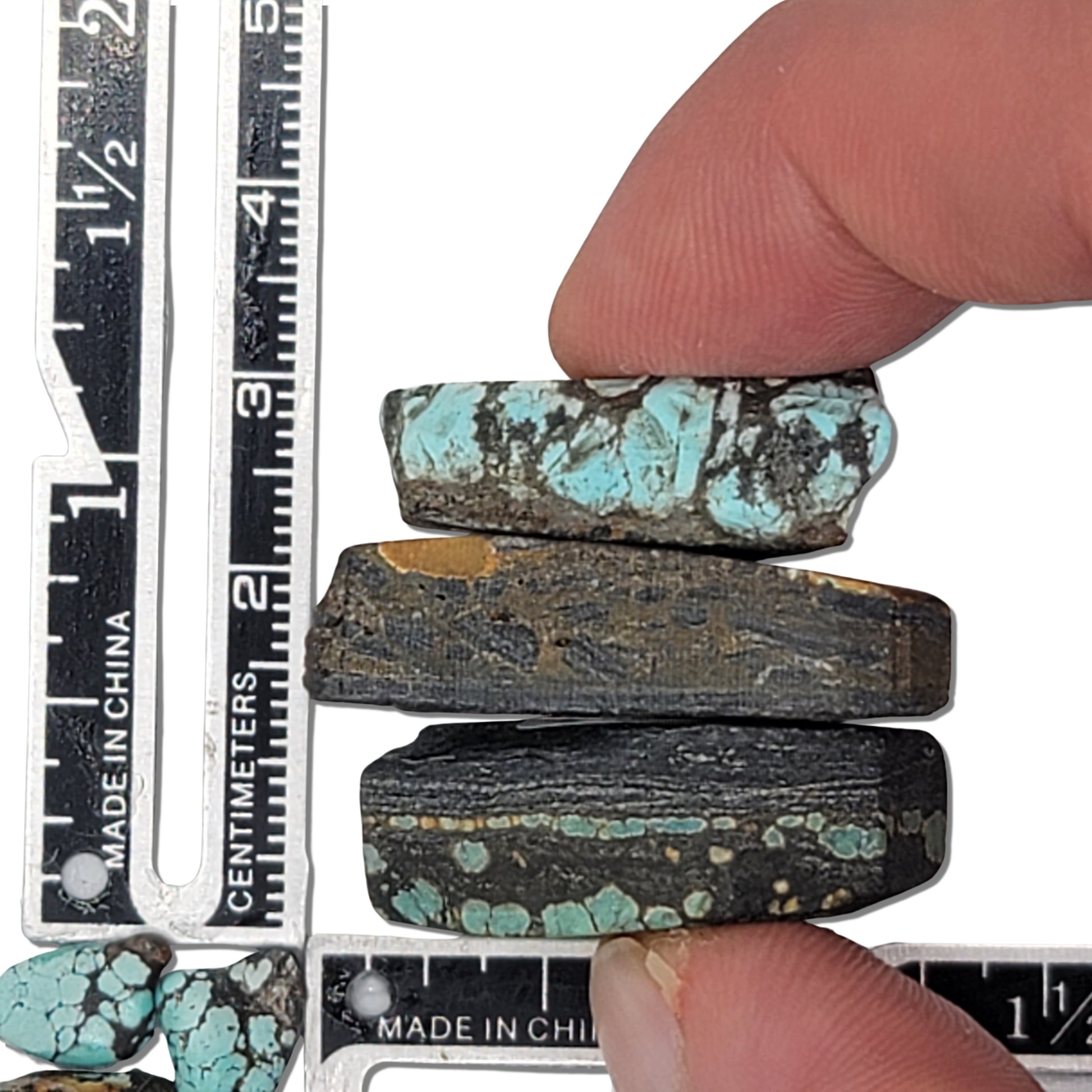 A set of three natural turquoise rough stones, 19 grams in total, featuring vibrant blue hues with earthy brown and black matrix. Perfect for jewelry and lapidary projects. Available at www.naturalturquoise.com