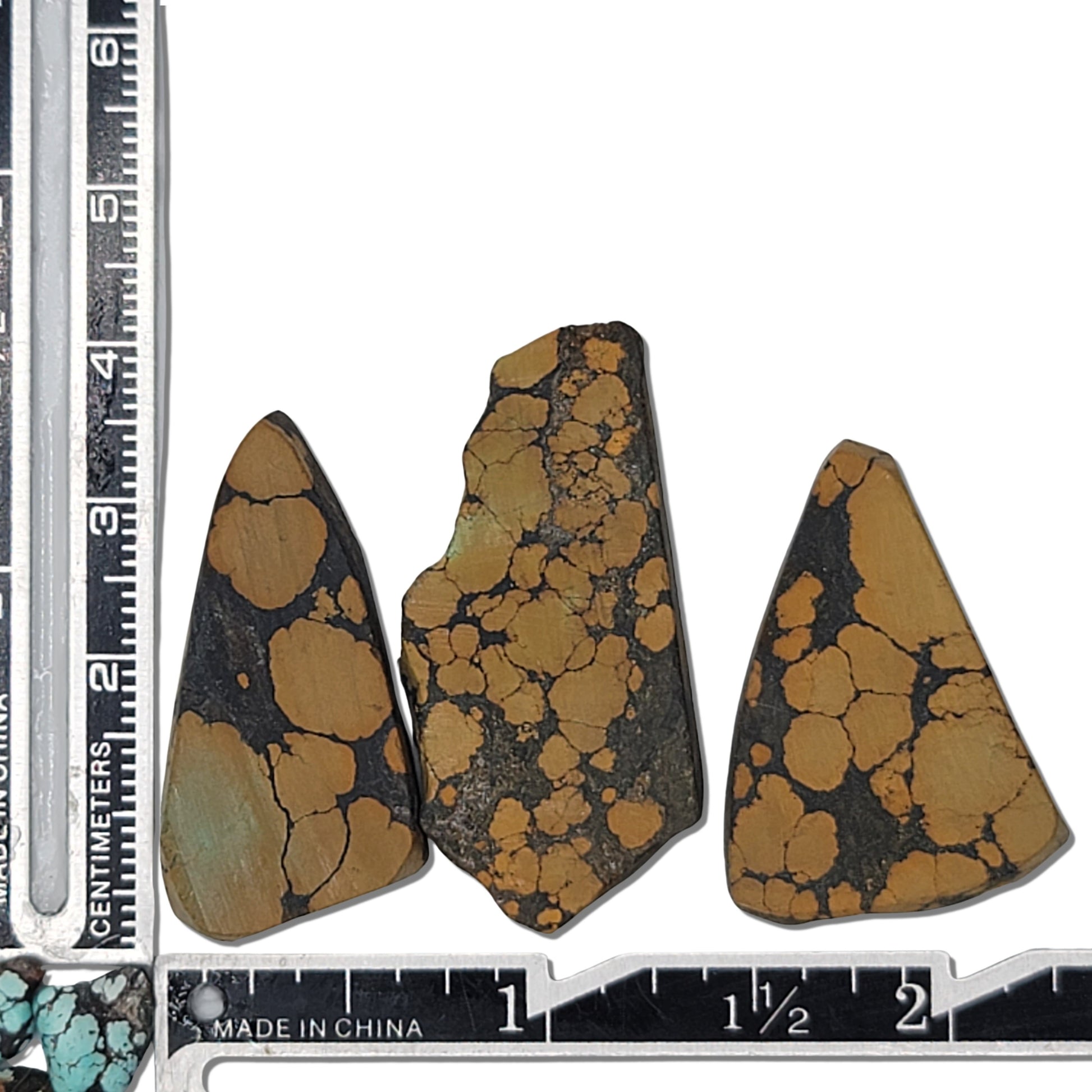 A triplet of natural turquoise rough stones weighing 15 grams, showcasing warm golden and dark brown patterns. Ideal for jewelry-making and lapidary use, now on www.naturalturquoise.com.