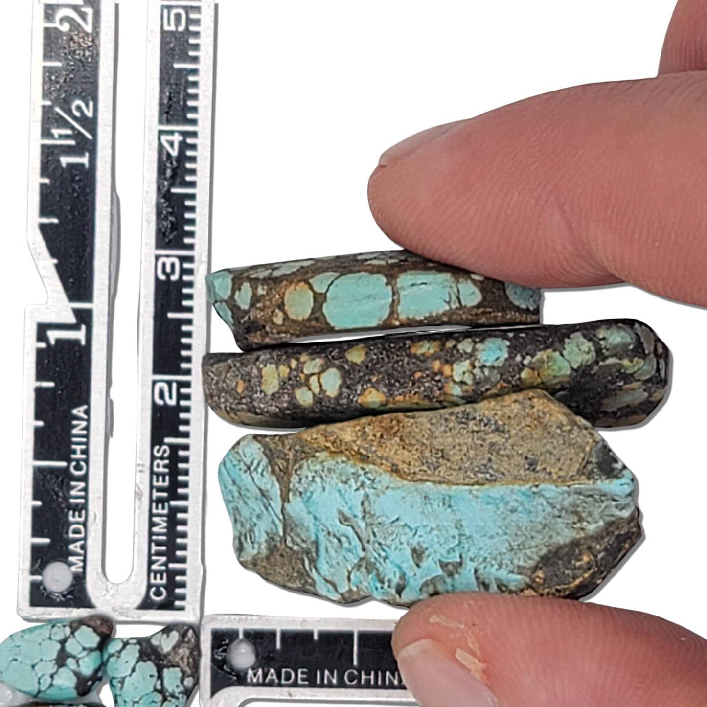 An 18-gram triplet of natural turquoise stones featuring vibrant blue hues with rich brown and golden matrix patterns. Perfect for custom jewelry or lapidary projects, available at www.naturalturquoise.com