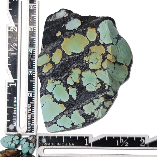 Single rough turquoise stone with greenish tones and dark matrix patterns, approx. 5.5 cm x 5 cm, www.naturalturquoise.com.