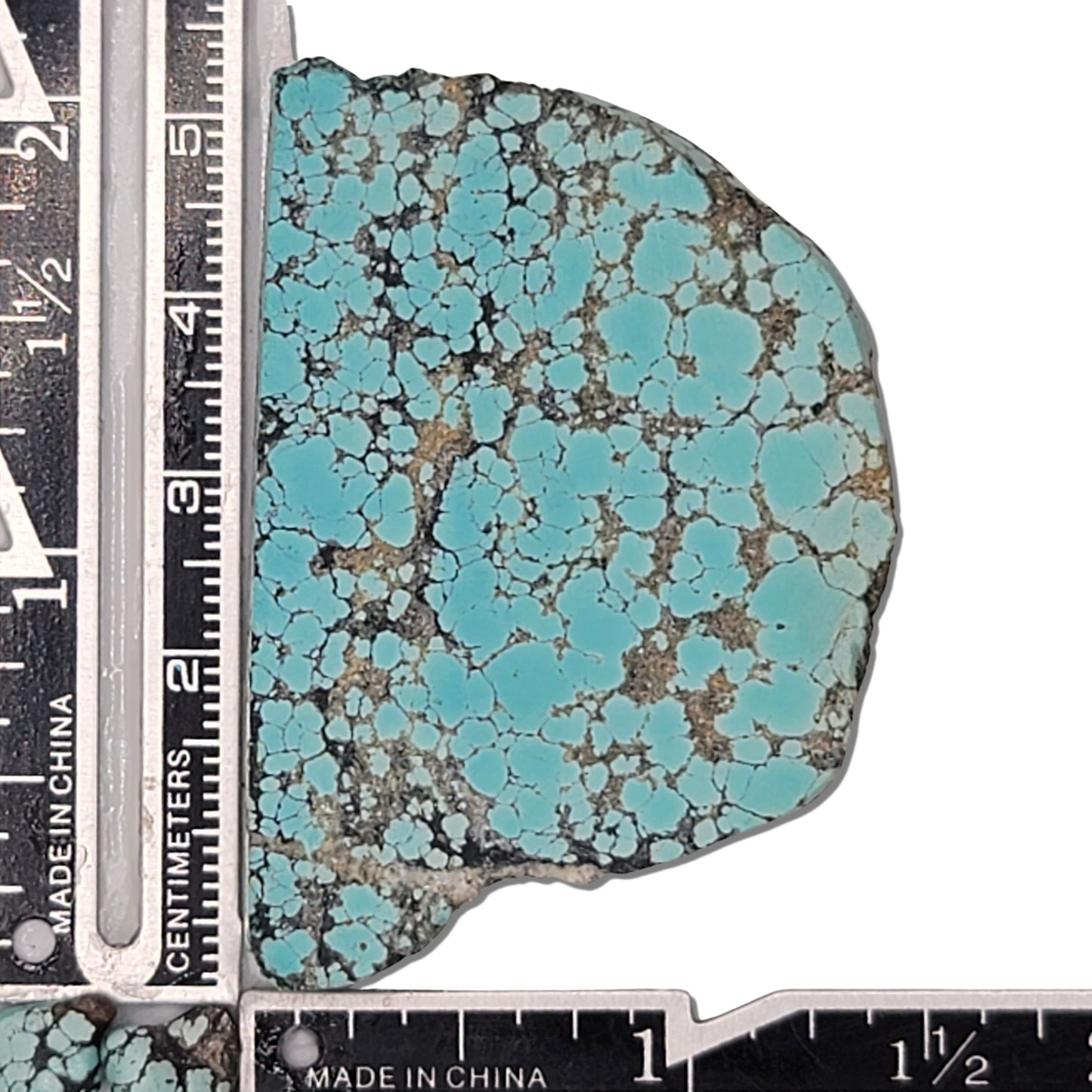 A vibrant 22-gram natural turquoise stone with striking sky-blue colors and a contrasting black matrix, ideal for jewelry designs or collectors, available at www.naturalturquoise.com.