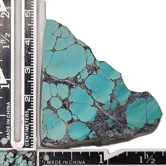 A 20-gram turquoise stone with vivid sky-blue hues and a bold dark matrix, ideal for jewelry or lapidary projects. Available at www.naturalturquoise.com.