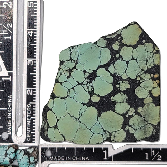 Single rough turquoise stone with green hues and dark webbing matrix, approx. 4 cm x 3 cm, www.naturalturquoise.com.