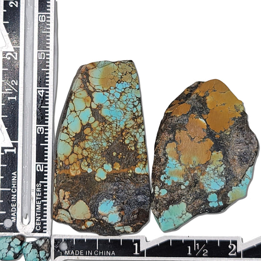 Pair of rough turquoise stones with vibrant blue, brown, and black matrix patterns, shown with measuring scale for size reference – high-quality natural turquoise stones for jewelry making at NaturalTurquoise.com.