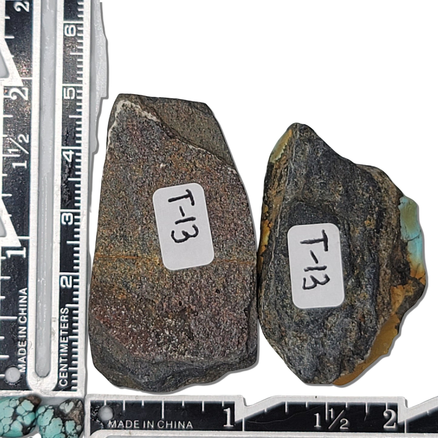 Pair of rough turquoise stones with vibrant blue, brown, and black matrix patterns, shown with measuring scale for size reference – high-quality natural turquoise stones for jewelry making at NaturalTurquoise.com.