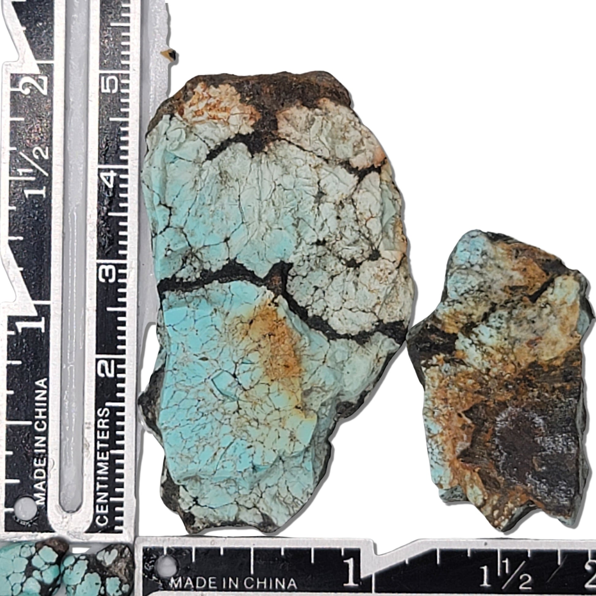 Two rough turquoise stones with blue hues and earthy matrix patterns, approx. 4 cm x 2.5 cm and 2.5 cm x 1.5 cm, www.naturalturquoise.com