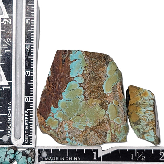 Two rough turquoise stones with greenish-blue tones and earthy brown matrix, approx. 4 cm x 3.5 cm and 2.5 cm x 1.5 cm, www.naturalturquoise.com.