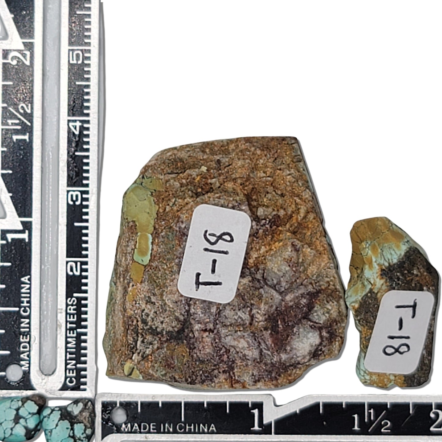 Two rough turquoise stones with greenish-blue tones and earthy brown matrix, approx. 4 cm x 3.5 cm and 2.5 cm x 1.5 cm, www.naturalturquoise.com.