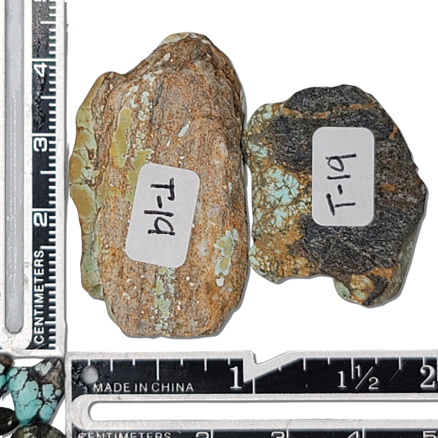 Two rough turquoise stones with earthy brown and green hues and subtle matrix patterns, approx. 4 cm x 2.5 cm and 3 cm x 2 cm, www.naturalturquoise.com.