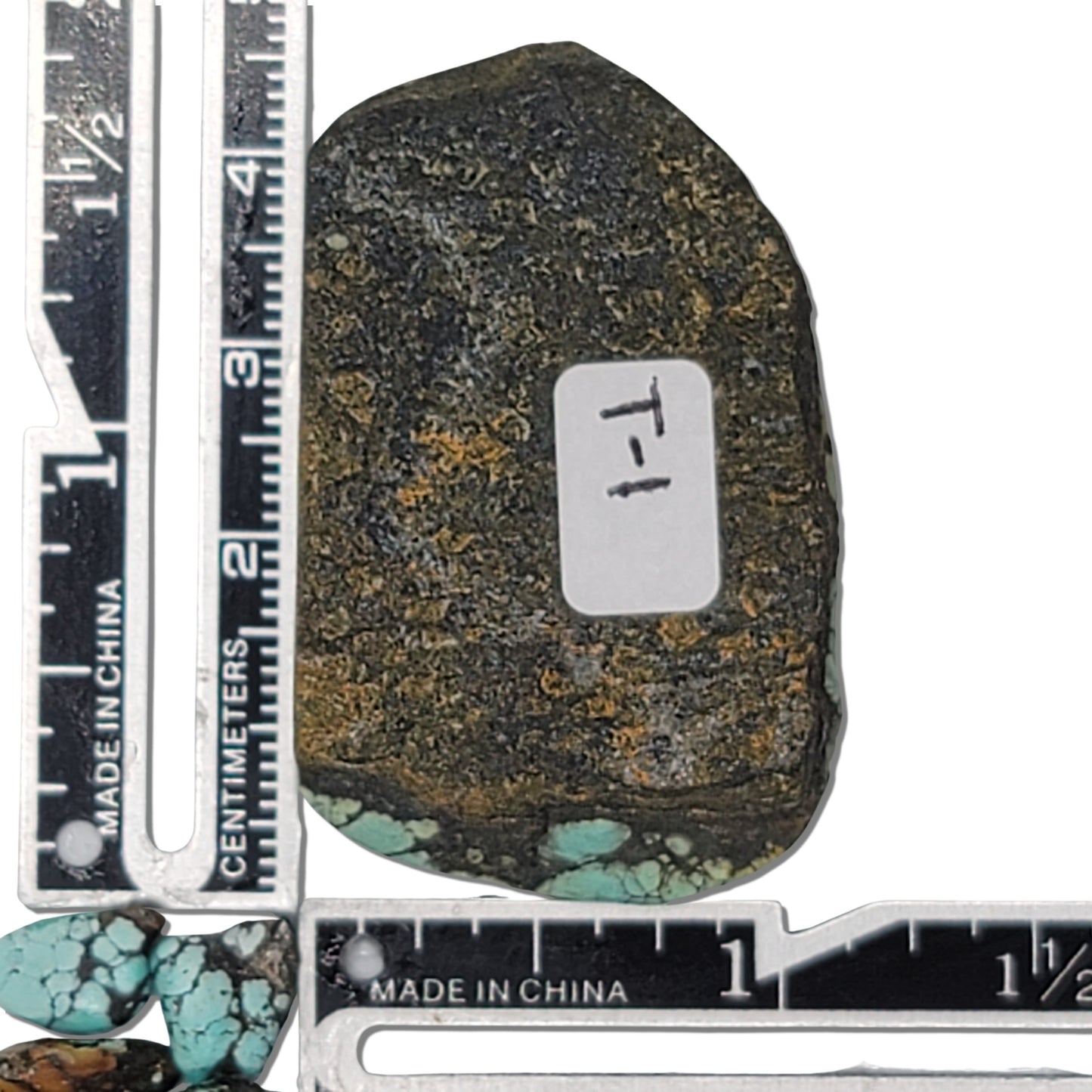 Natural turquoise rough stone with vibrant blue coloring and intricate black web matrix pattern, shown with measuring scale for size reference – premium turquoise for jewelry making at NaturalTurquoise.com.