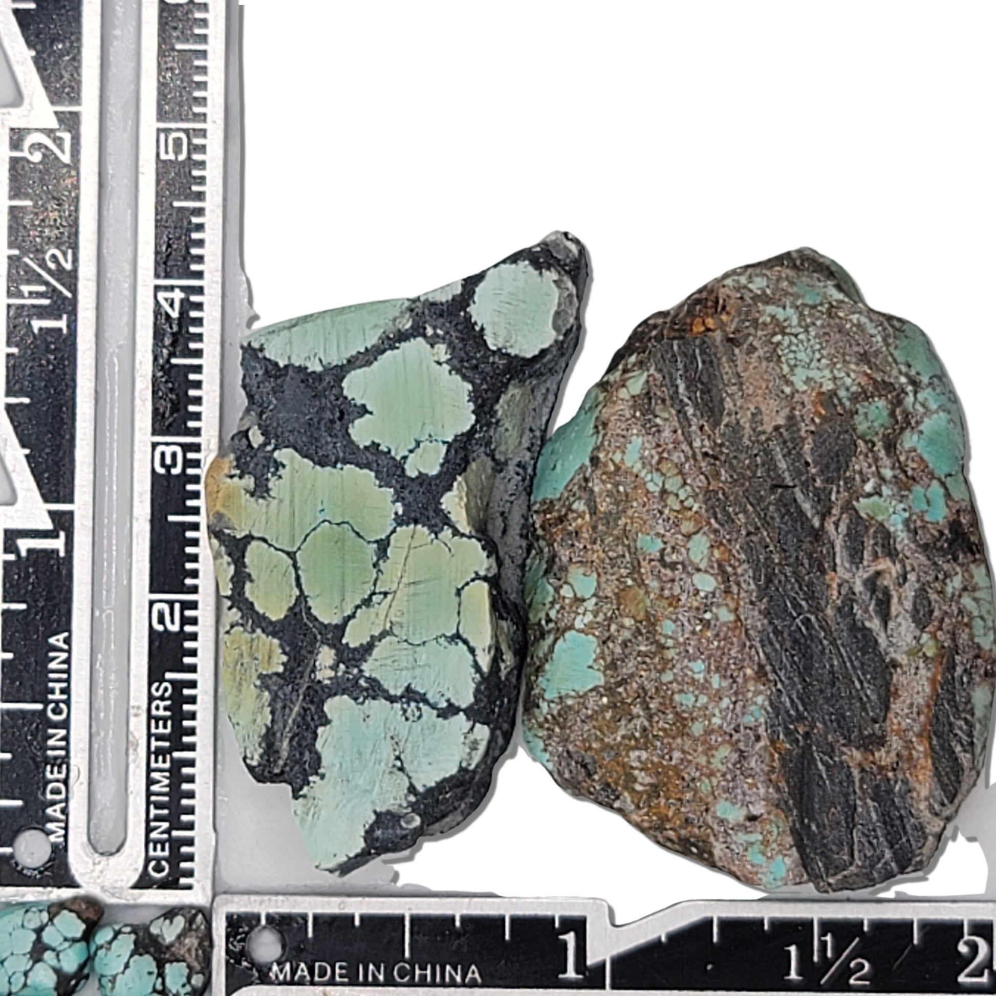 Two rough turquoise stones with greenish hues and dark matrix patterns, approx. 4 cm x 2 cm and 3.5 cm x 2.5 cm, www.naturalturquoise.com.