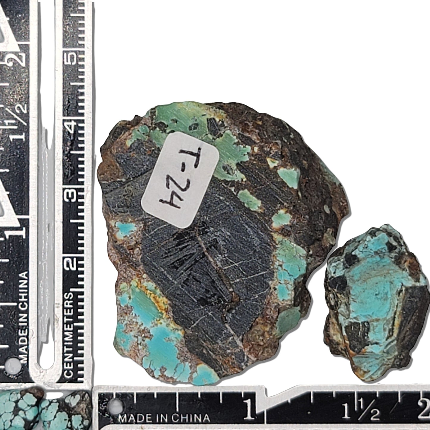 Two rough turquoise stones with green and brown tones and dark matrix, approx. 4 cm x 3 cm and 2 cm x 1.5 cm, www.naturalturquoise.com.