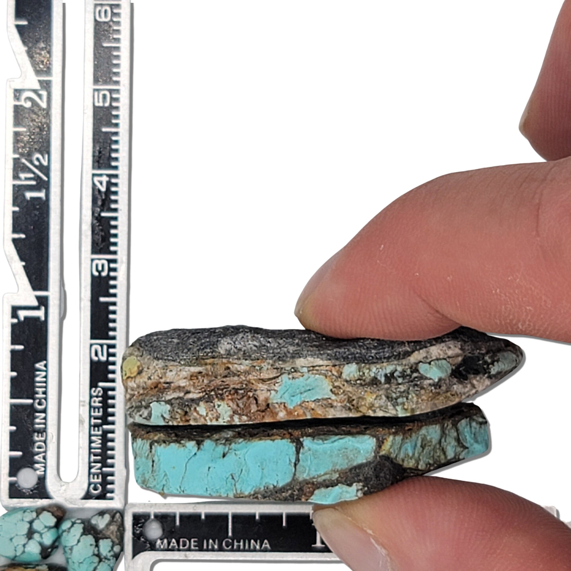 Two rough turquoise stones with vivid blue and dark brown matrix patterns, approx. 4 cm x 2.5 cm and 3.5 cm x 2 cm, www.naturalturquoise.com