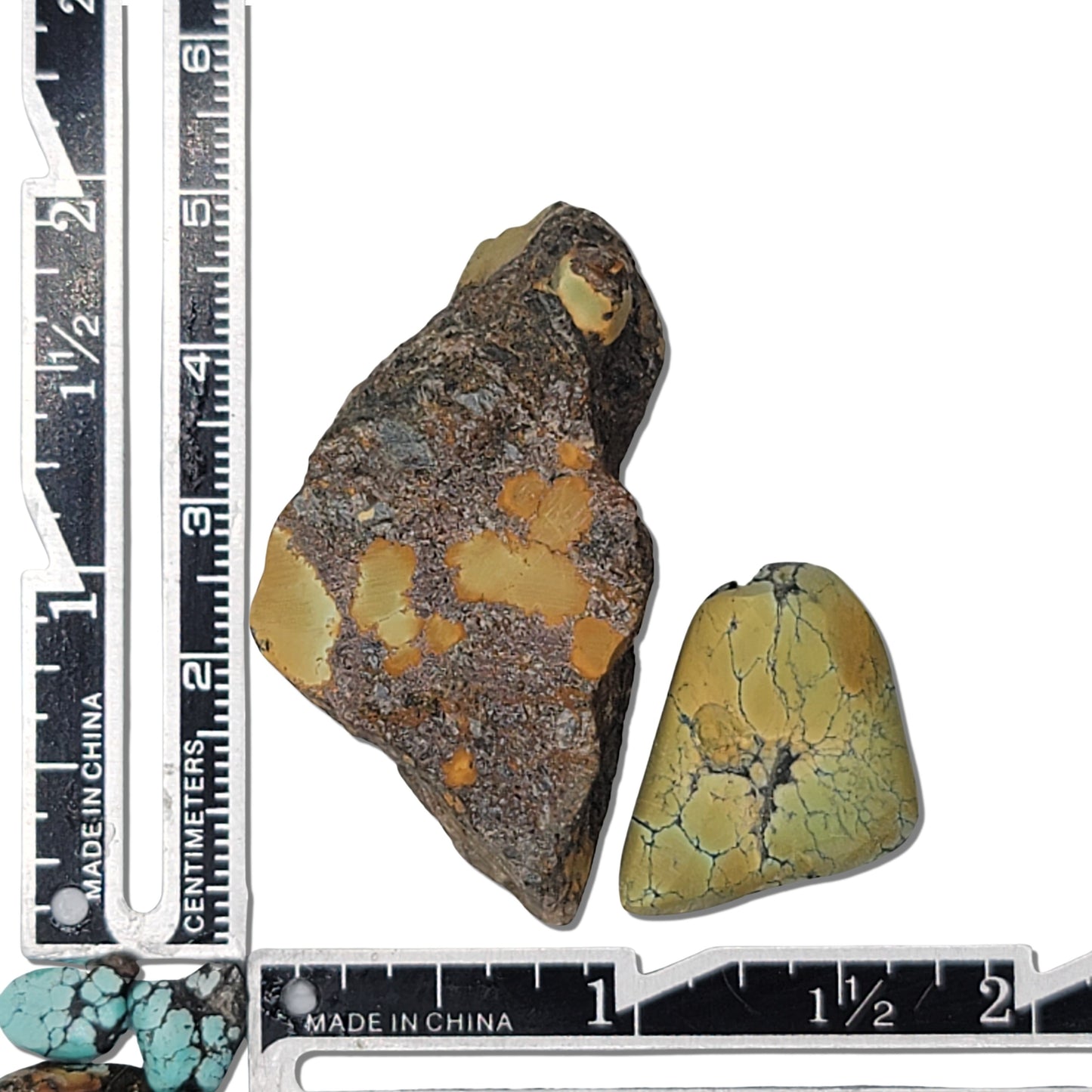 Two rough turquoise stones with earthy brown and yellowish-green tones, featuring natural matrix patterns, approx. 4 cm x 2.5 cm and 2.5 cm x 2 cm, www.naturalturquoise.com.