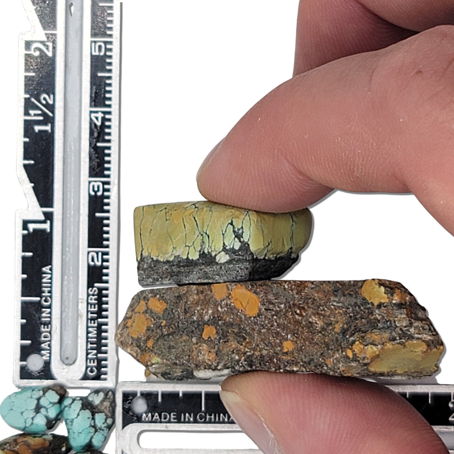 Two rough turquoise stones with earthy brown and yellowish-green tones, featuring natural matrix patterns, approx. 4 cm x 2.5 cm and 2.5 cm x 2 cm, www.naturalturquoise.com.