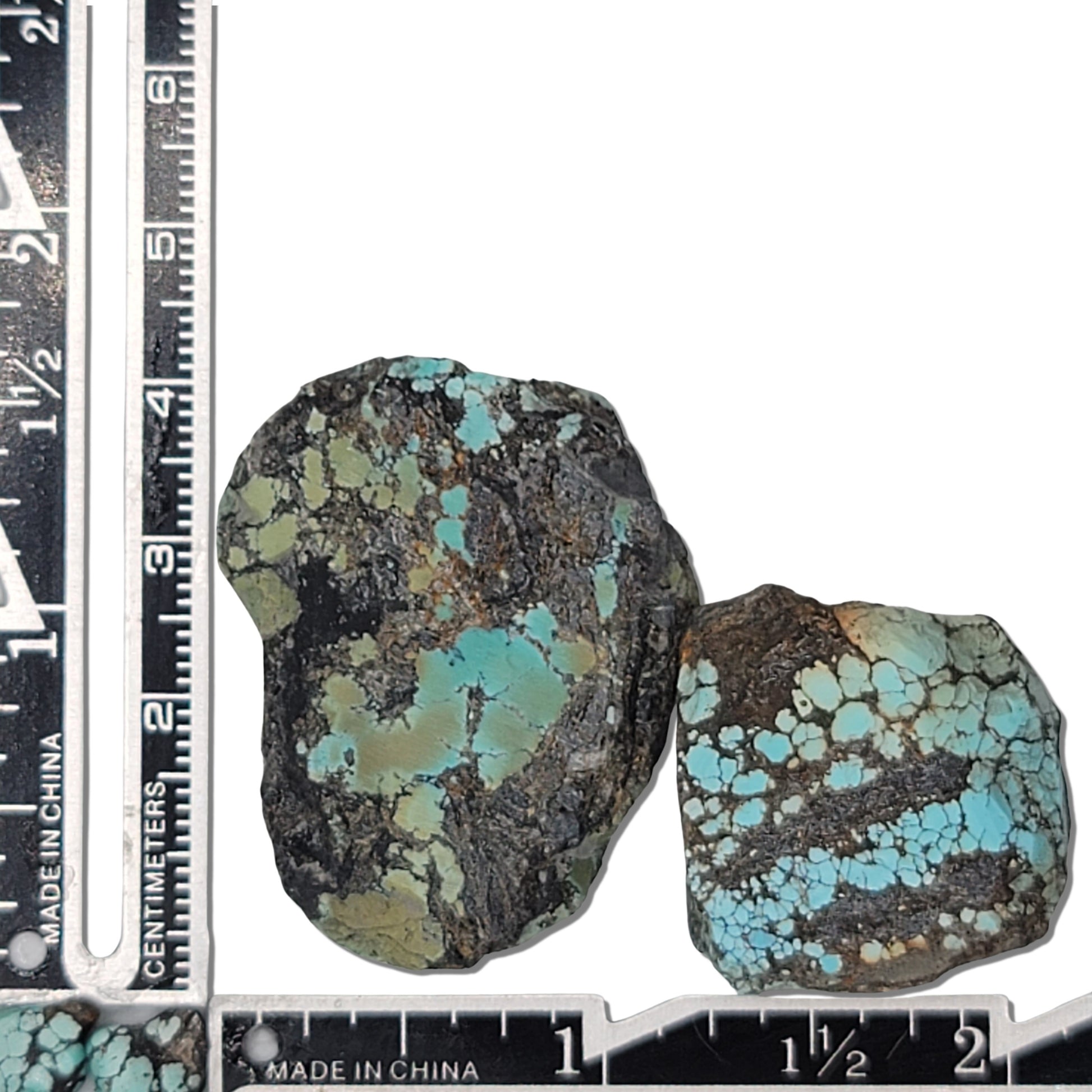 Two rough turquoise stones with green and blue hues and dark matrix, approx. 4 cm x 3 cm and 3 cm x 2.5 cm, www.naturalturquoise.com.