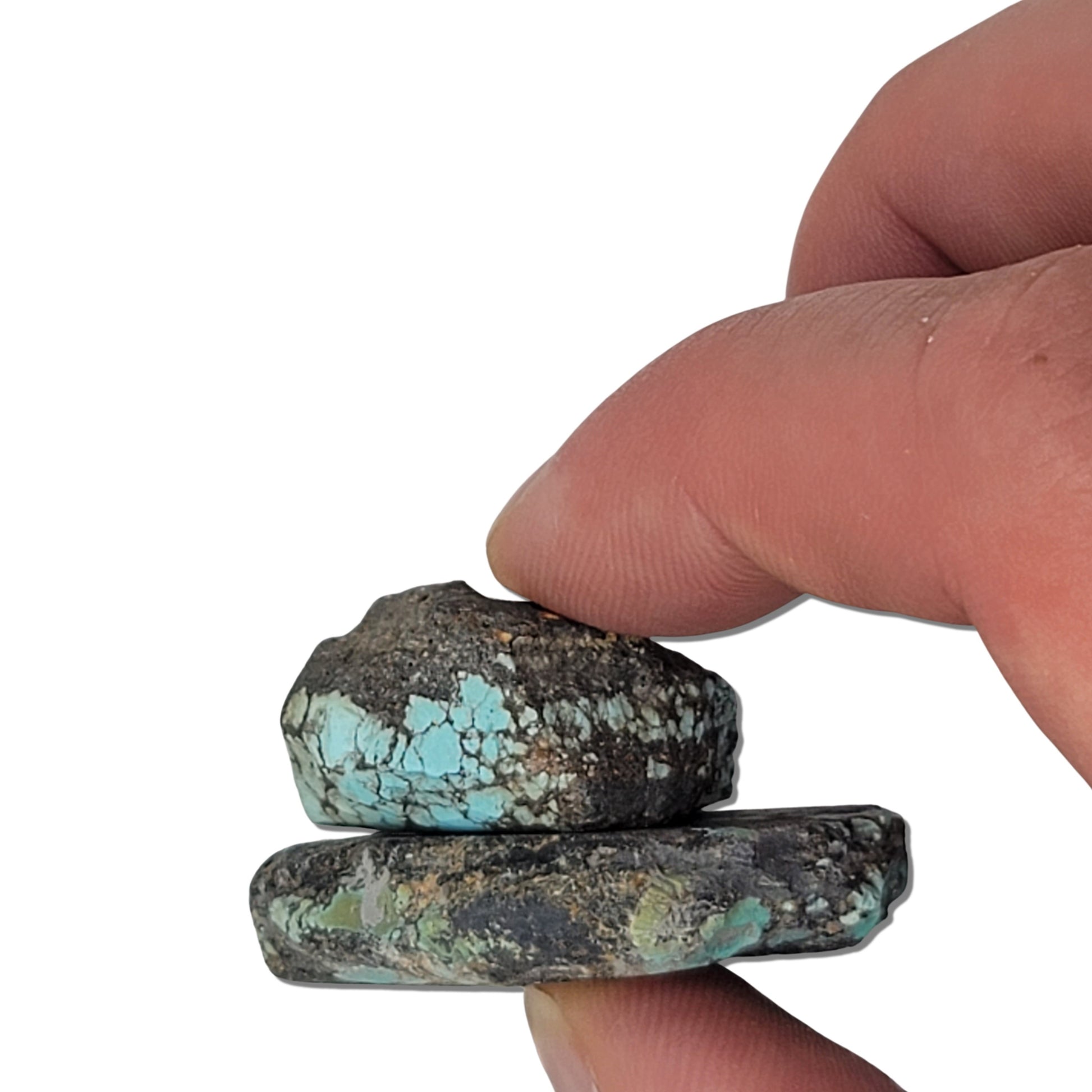 Two rough turquoise stones with green and blue hues and dark matrix, approx. 4 cm x 3 cm and 3 cm x 2.5 cm, www.naturalturquoise.com.