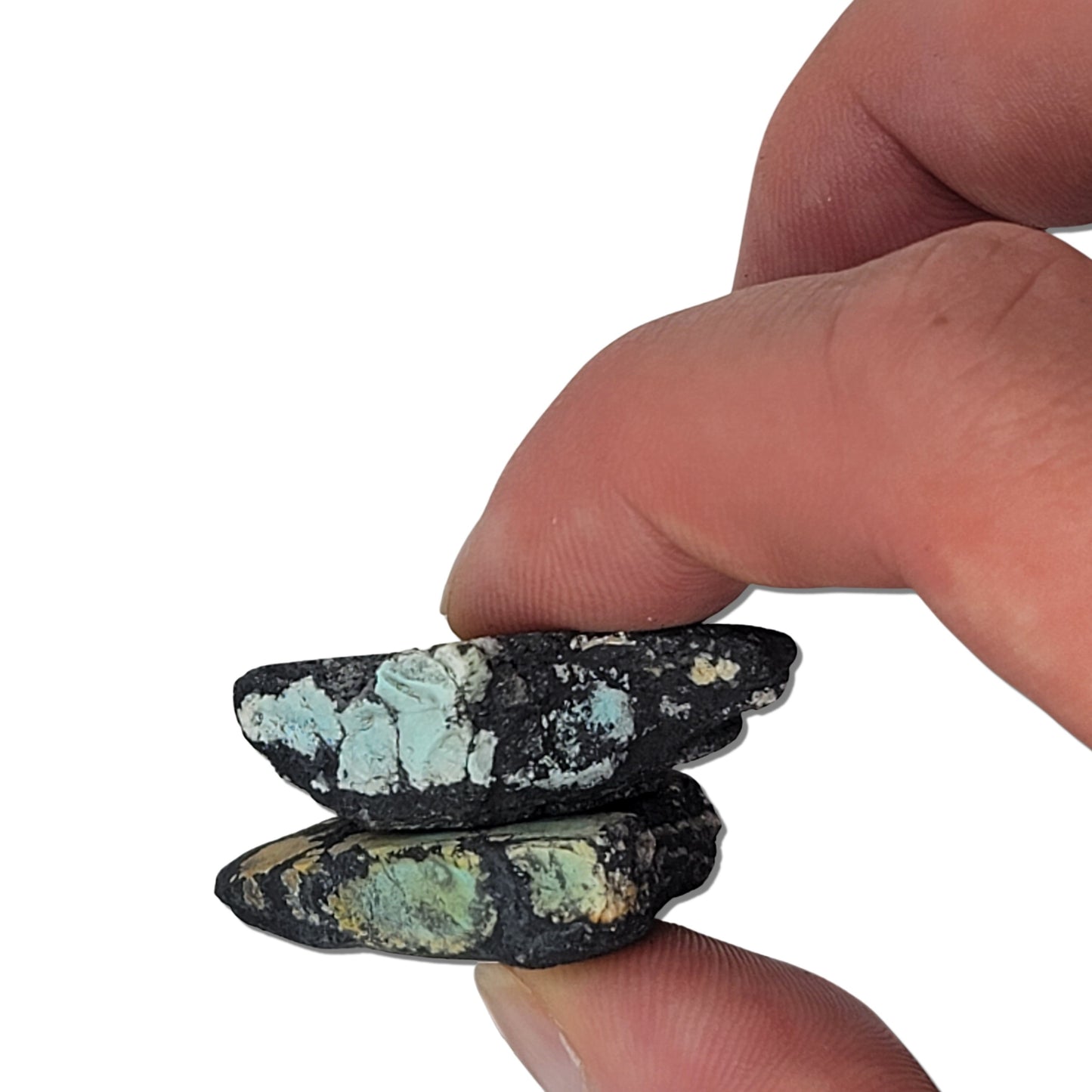 Two rough turquoise stones with black matrix and patches of light blue and earthy tones, approx. 3 cm x 3.5 cm and 3 cm x 3 cm, www.naturalturquoise.com.