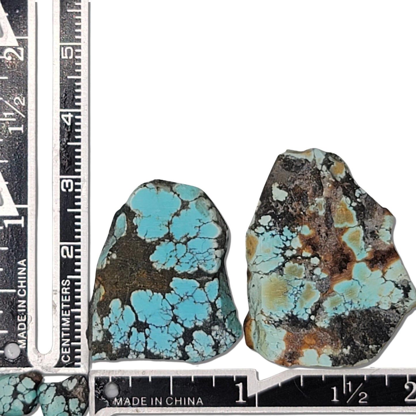 Two rough turquoise stones with blue webbing and black-brown matrix, approx. 1-2 inches, www.naturalturquoise.com