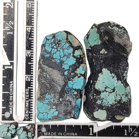 Two rough turquoise stones with blue webbing and dark matrix, approx. 4 cm x 2 cm each, www.naturalturquoise.com.