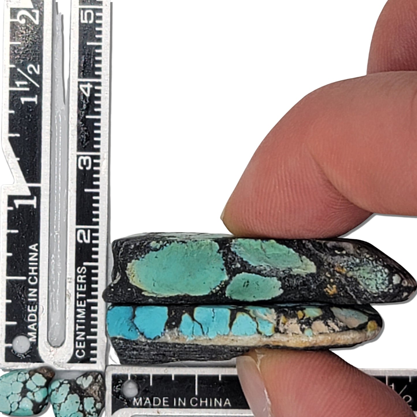 Two rough turquoise stones with blue webbing and dark matrix, approx. 4 cm x 2 cm each, www.naturalturquoise.com.