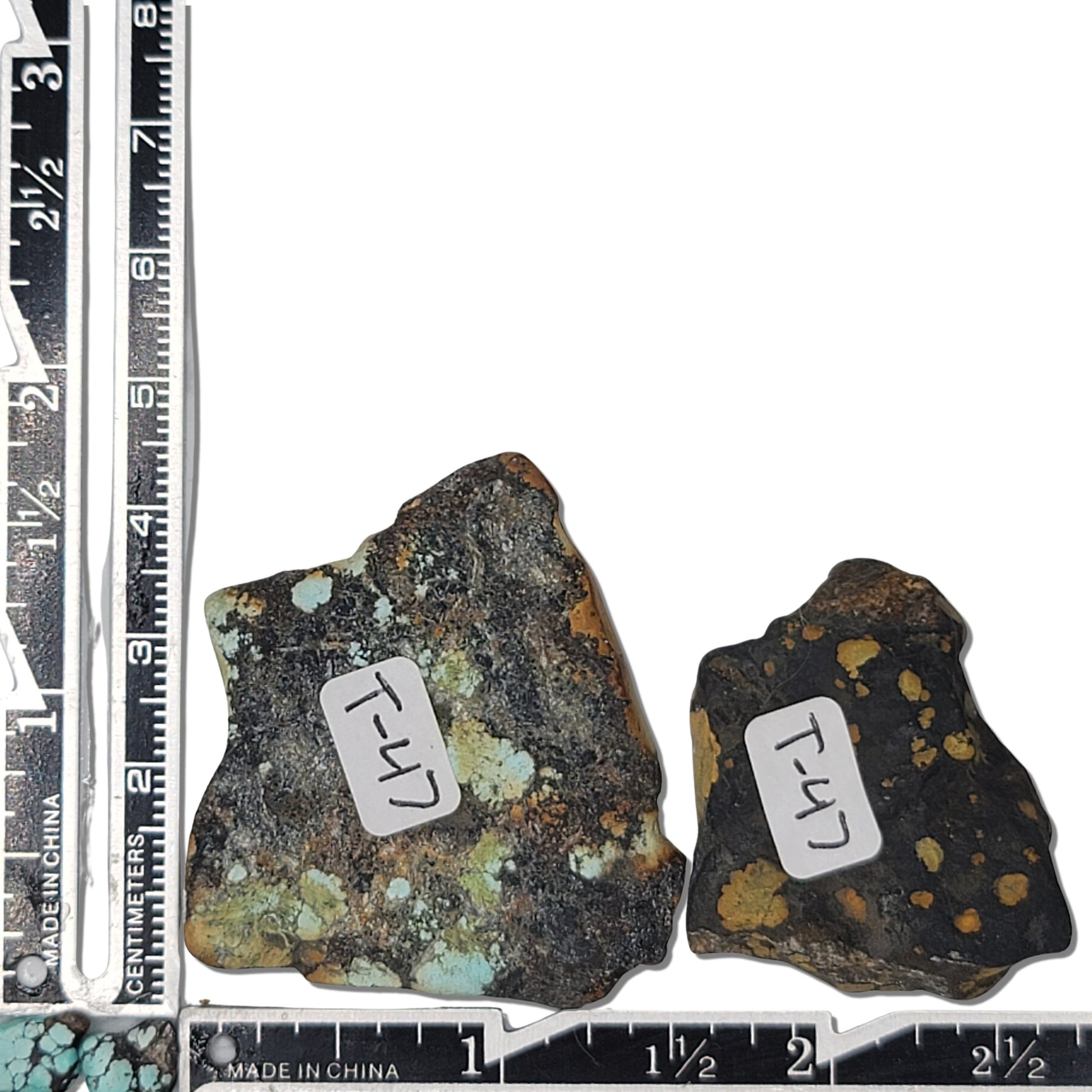 Two rough turquoise stones with warm earthy tones and dark matrix patterns, approx. 4 cm x 3.5 cm and 3 cm x 2.5 cm, www.naturalturquoise.com.