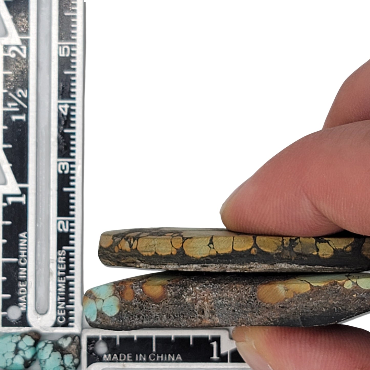 Pair of natural Hubei turquoise stones, 29g total, earthy tan, green, and blue hues with dark matrix, elongated shapes, approx. 5 cm x 2.5 cm each, www.naturalturquoise.com.