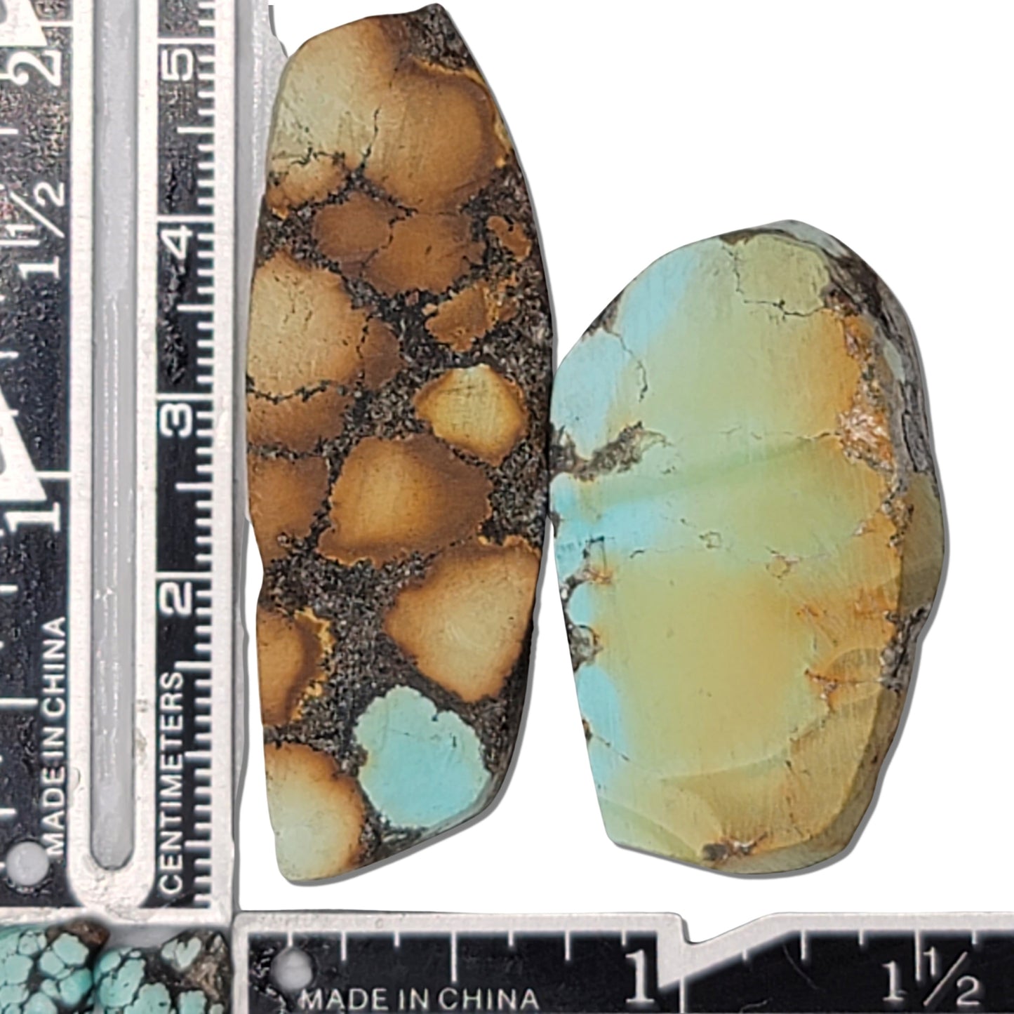 Pair of Hubei turquoise stones, 23g total, tan-brown with black matrix and soft green with subtle matrix, sizes approx. 4 cm x 2 cm and 3.5 cm x 2 cm, www.naturalturquoise.com.