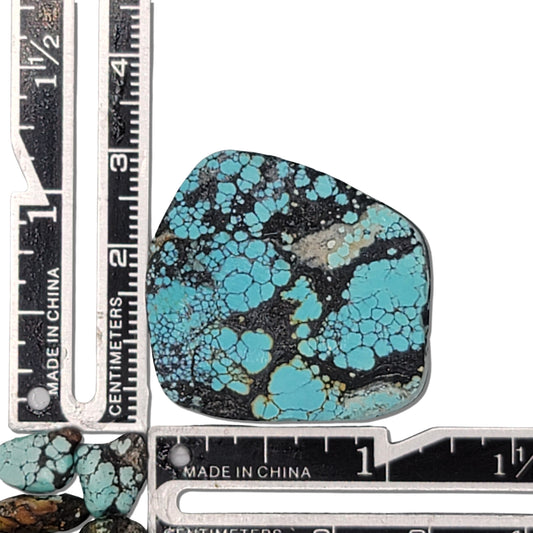 Single rough turquoise stone with bright blue webbing and dark matrix, approx. 3 cm x 2.5 cm, www.naturalturquoise.com.