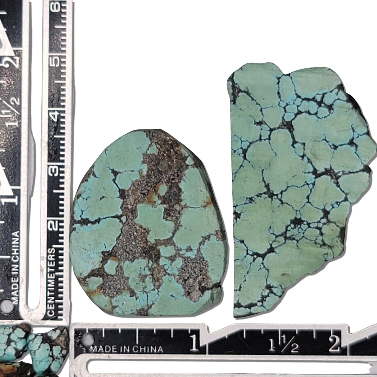 A pair of natural turquoise stones with light blue-green color and dark matrix patterns, measuring approximately 4.5 cm x 3.5 cm and 5 cm x 3 cm, displayed alongside a ruler for scale. Perfect for jewelry making or lapidary projects.