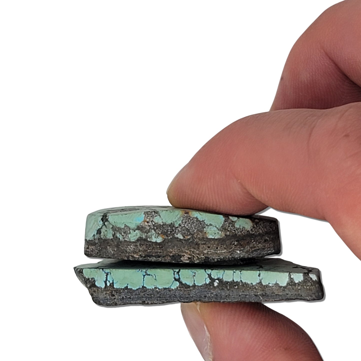 A pair of natural turquoise stones with light blue-green color and dark matrix patterns, measuring approximately 4.5 cm x 3.5 cm and 5 cm x 3 cm, displayed alongside a ruler for scale. Perfect for jewelry making or lapidary projects.