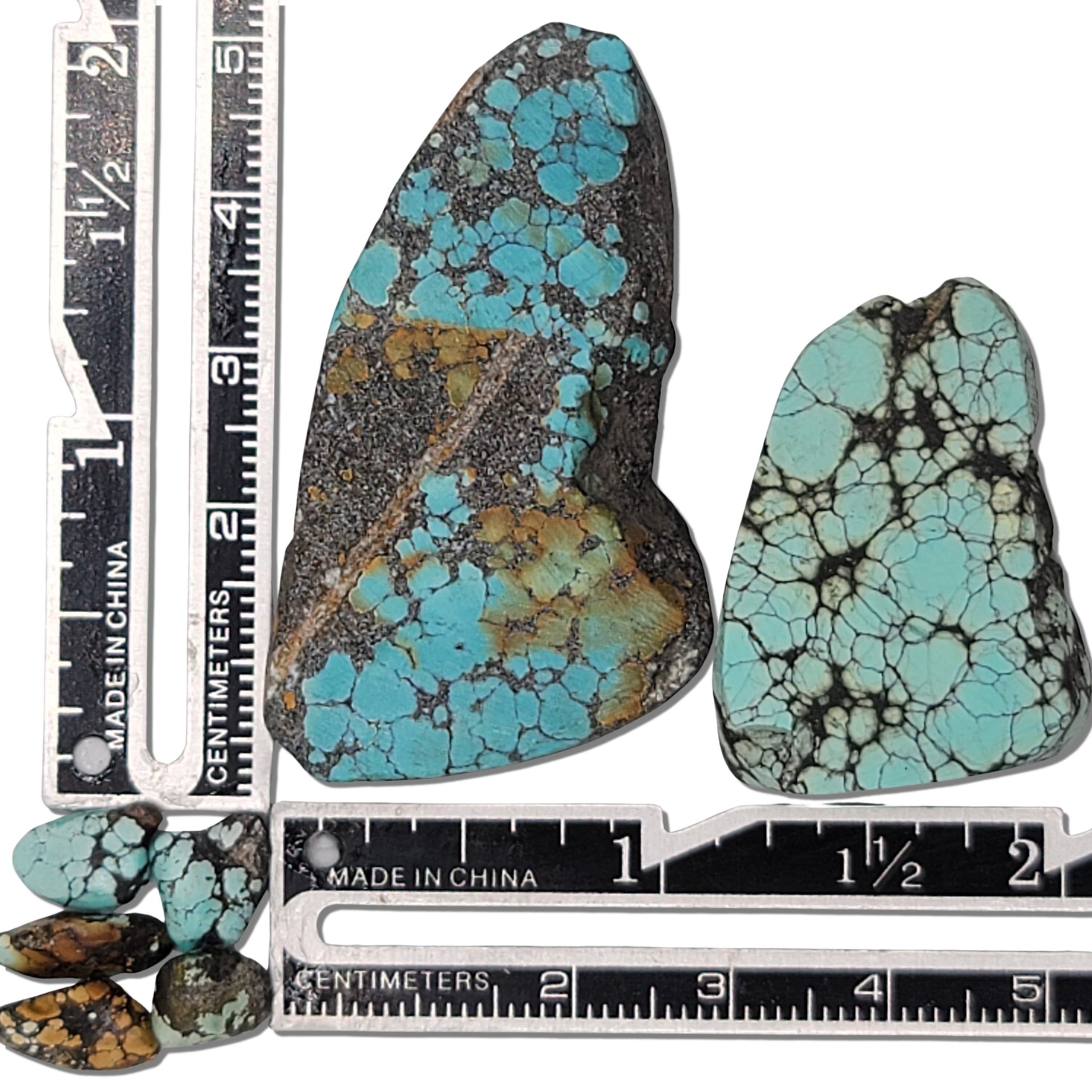 Two rough turquoise stones with striking blue webbing and dark earthy matrix, approx. 4 cm x 2.5 cm and 3.5 cm x 2 cm, www.naturalturquoise.com.