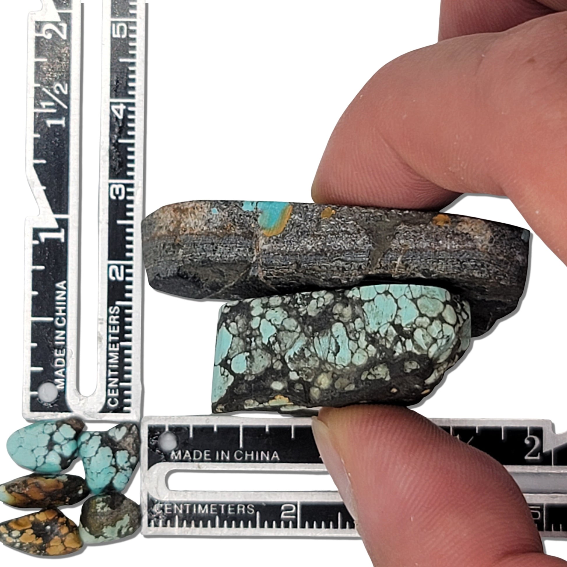 Two rough turquoise stones with striking blue webbing and dark earthy matrix, approx. 4 cm x 2.5 cm and 3.5 cm x 2 cm, www.naturalturquoise.com.