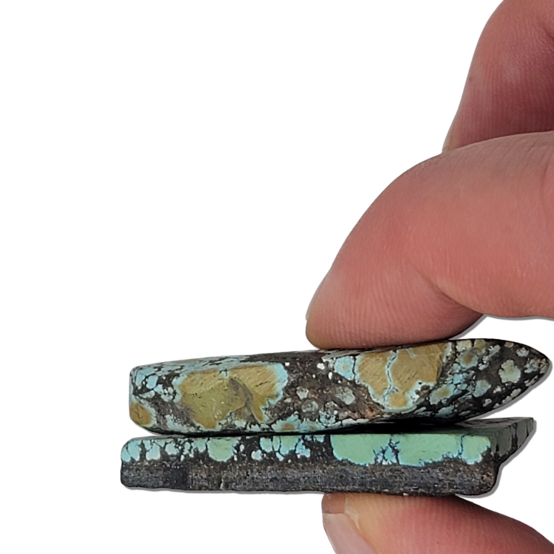 A pair of natural turquoise stones weighing 21 grams, featuring blue-green tones with golden and dark matrix patterns. The stones measure approximately 4.2 cm x 3.3 cm and 4.5 cm x 2 cm, displayed with a ruler for scale. Available for purchase at www.naturalturquoise.com, ideal for lapidary and jewelry projects.