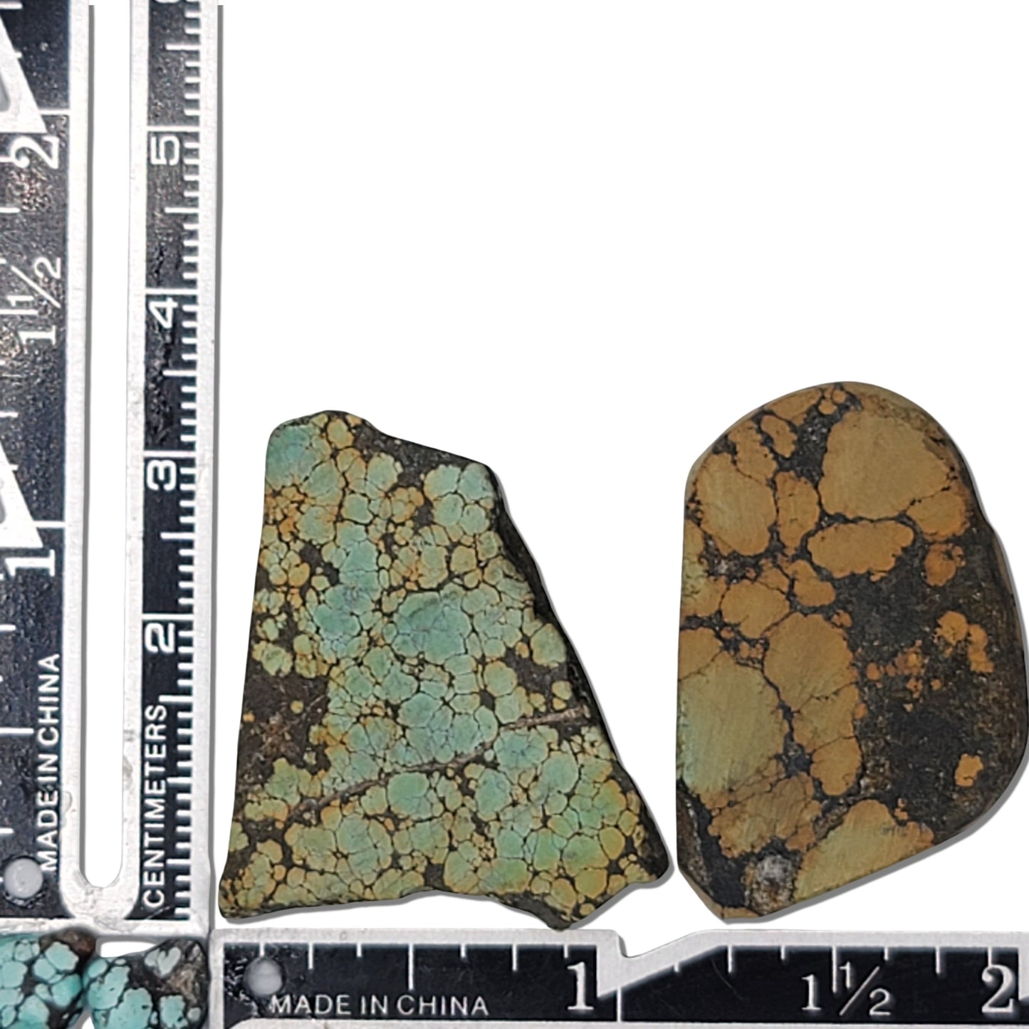 A pair of natural turquoise stones weighing 18 grams, featuring light green and golden tones with bold dark matrix patterns. The stones measure approximately 4.2 cm x 3 cm and 3.5 cm x 2.7 cm, displayed with a ruler for scale. Available for purchase at www.naturalturquoise.com, ideal for lapidary and jewelry projects.