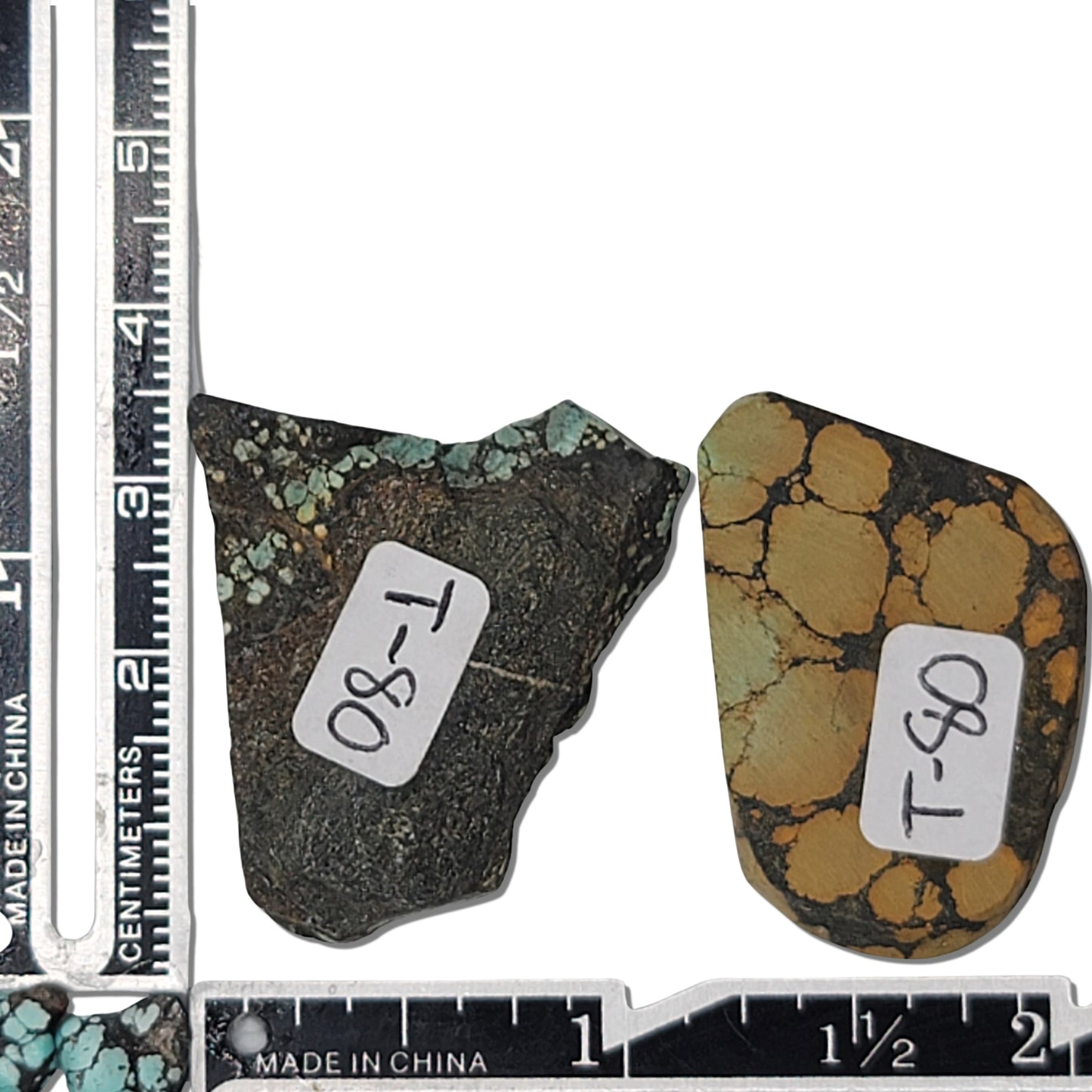 A pair of natural turquoise stones weighing 18 grams, featuring light green and golden tones with bold dark matrix patterns. The stones measure approximately 4.2 cm x 3 cm and 3.5 cm x 2.7 cm, displayed with a ruler for scale. Available for purchase at www.naturalturquoise.com, ideal for lapidary and jewelry projects.