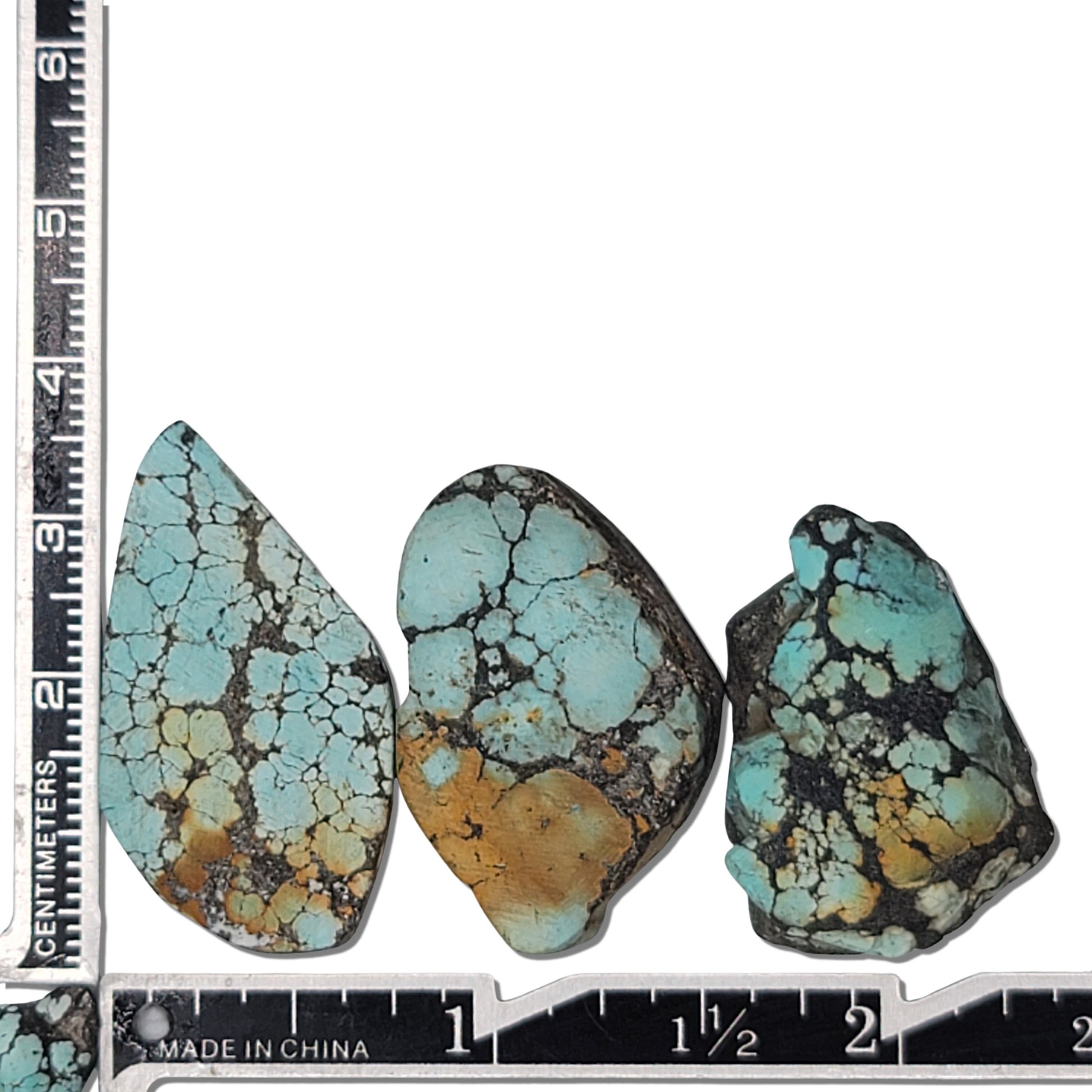 A natural turquoise stone triplet weighing 18 grams, featuring vibrant blue tones with golden accents and bold dark matrix patterns. The stones measure approximately 4.2 cm x 2.7 cm, 3.8 cm x 2.5 cm, and 3.5 cm x 2.3 cm, displayed with a ruler for scale. Available for purchase at www.naturalturquoise.com, ideal for jewelry making and lapidary projects.