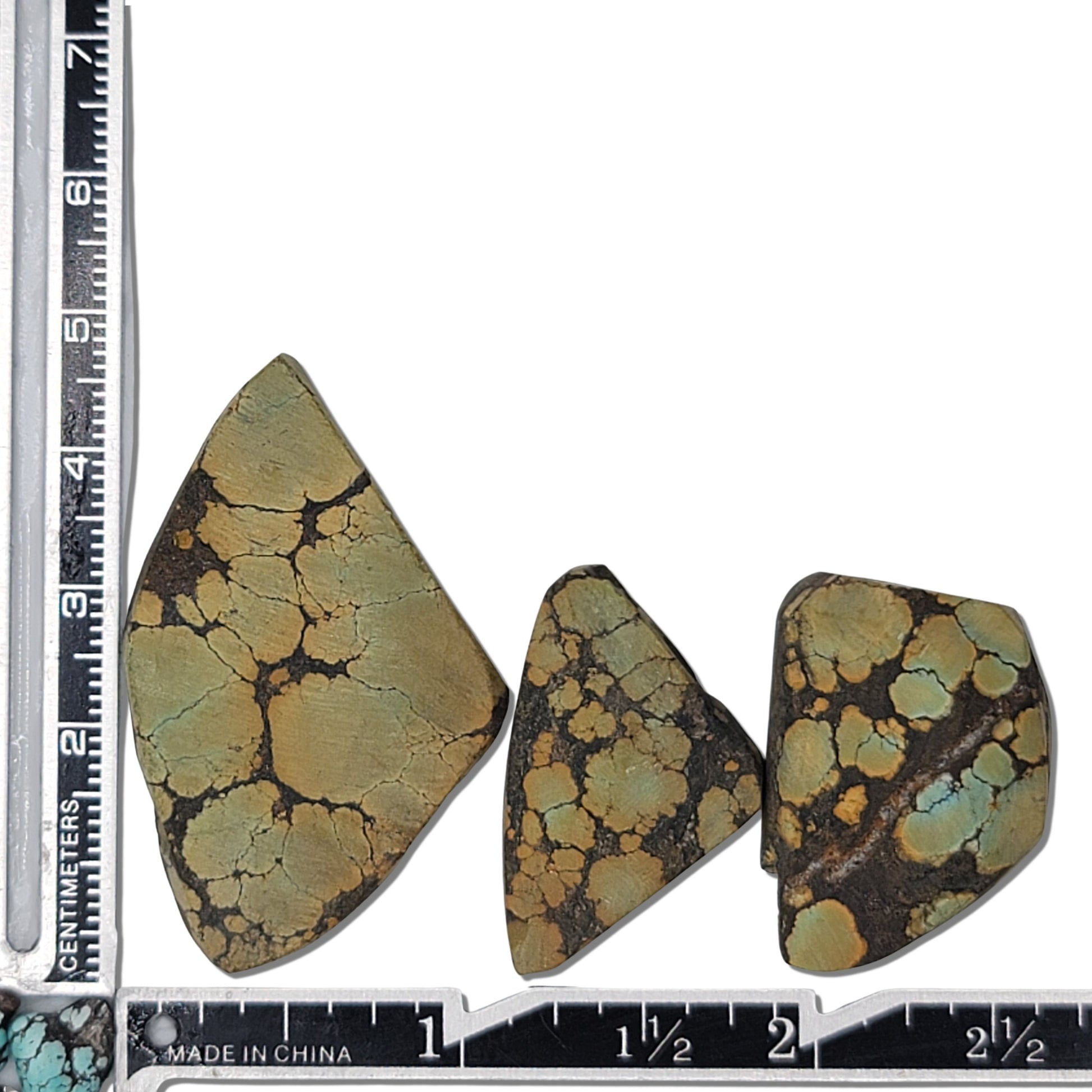 A natural turquoise stone triplet weighing 20 grams, featuring earthy green and golden tones with bold dark matrix patterns. The stones measure approximately 4.5 cm x 2.8 cm, 3.5 cm x 2.5 cm, and 3.2 cm x 2.3 cm, displayed with a ruler for scale. Available for purchase at www.naturalturquoise.com, ideal for lapidary and jewelry projects.