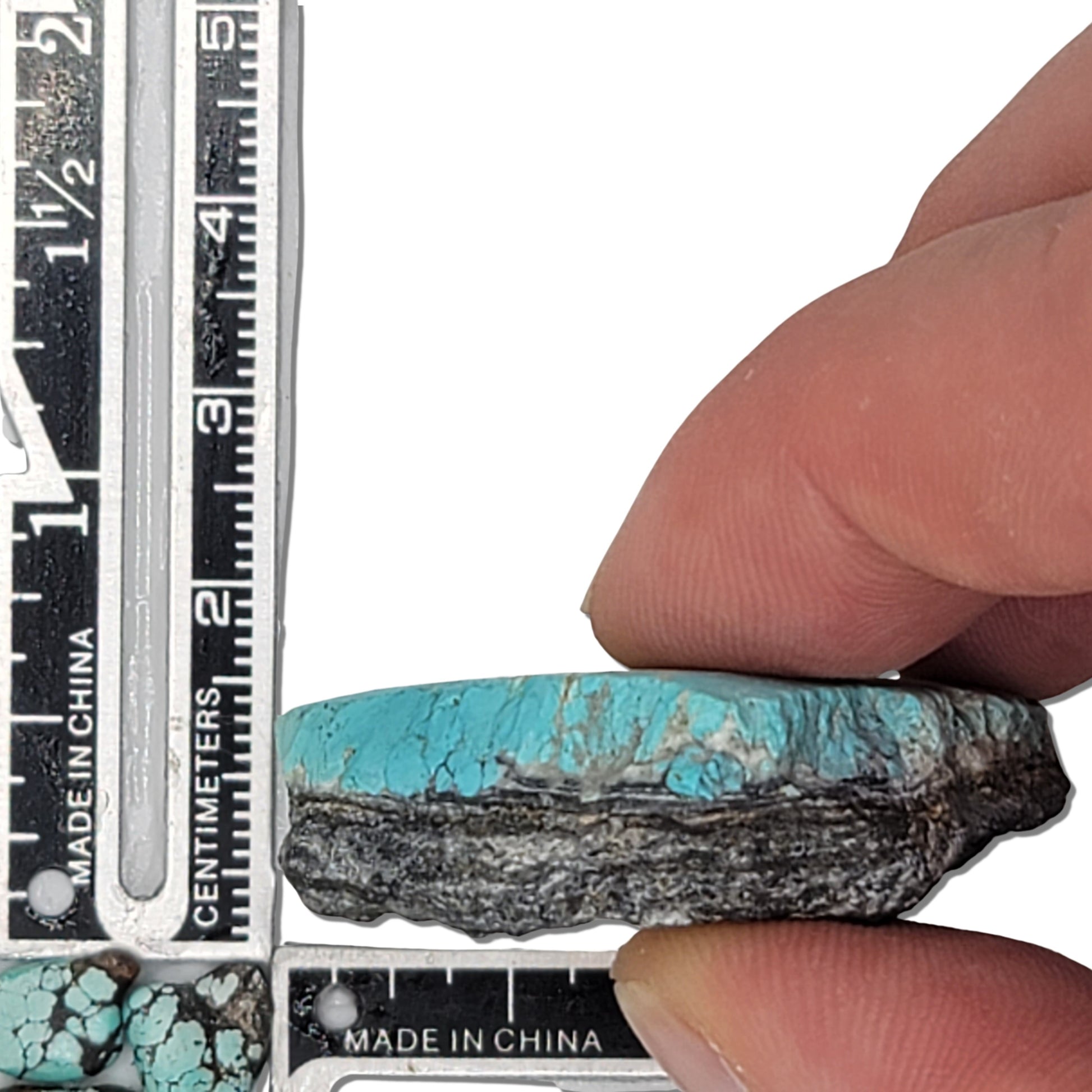 Natural turquoise rough stone with vibrant blue and earthy brown matrix, shown with measuring scale for size reference – high-quality turquoise for sale at NaturalTurquoise.com