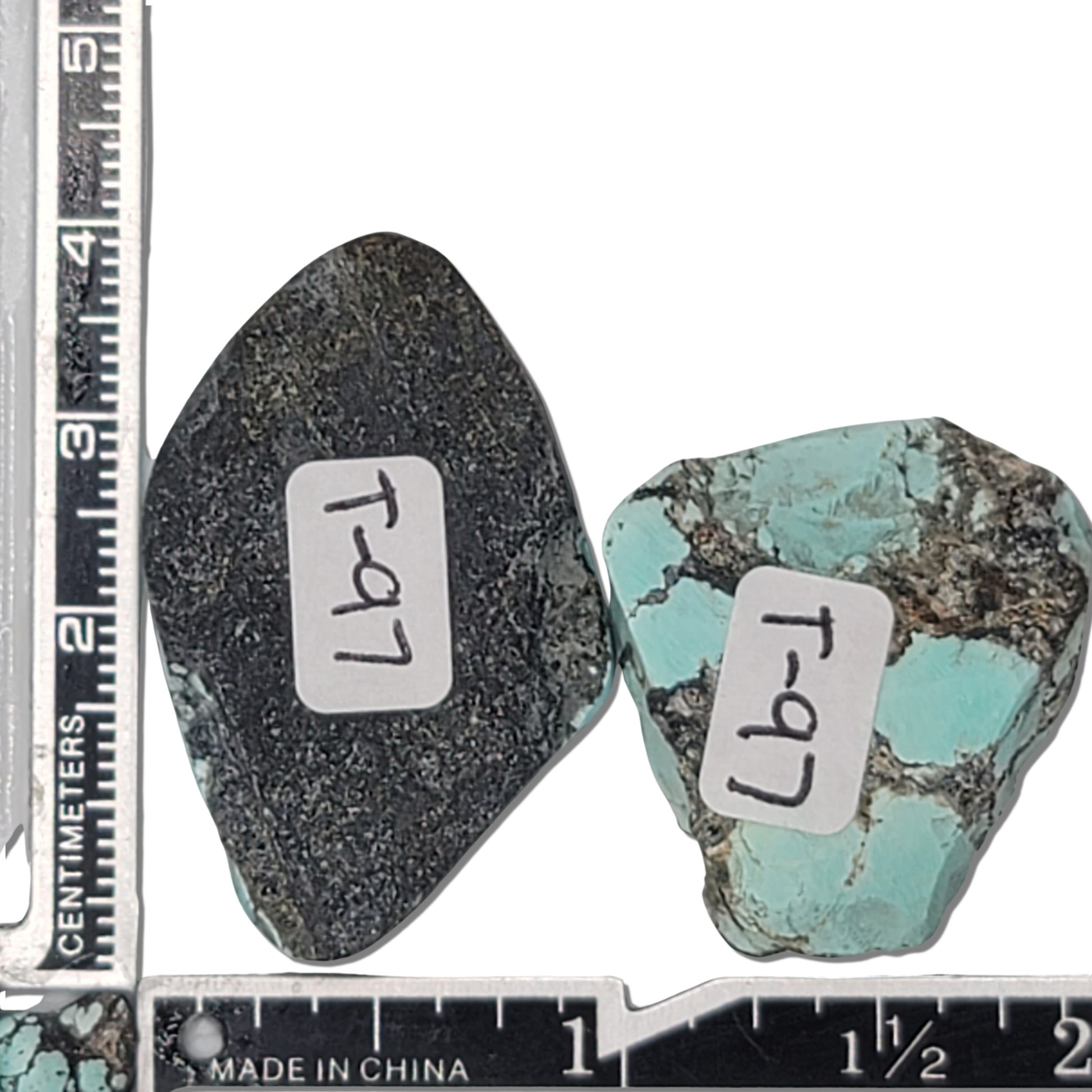 A pair of natural turquoise rough stones weighing 19 grams, featuring vibrant sky-blue tones with black and white matrix patterns. The largest stone measures approximately 3.7 cm x 2.5 cm x 0.7 cm. Ideal for jewelry making or lapidary projects, available at www.naturalturquoise.com.






